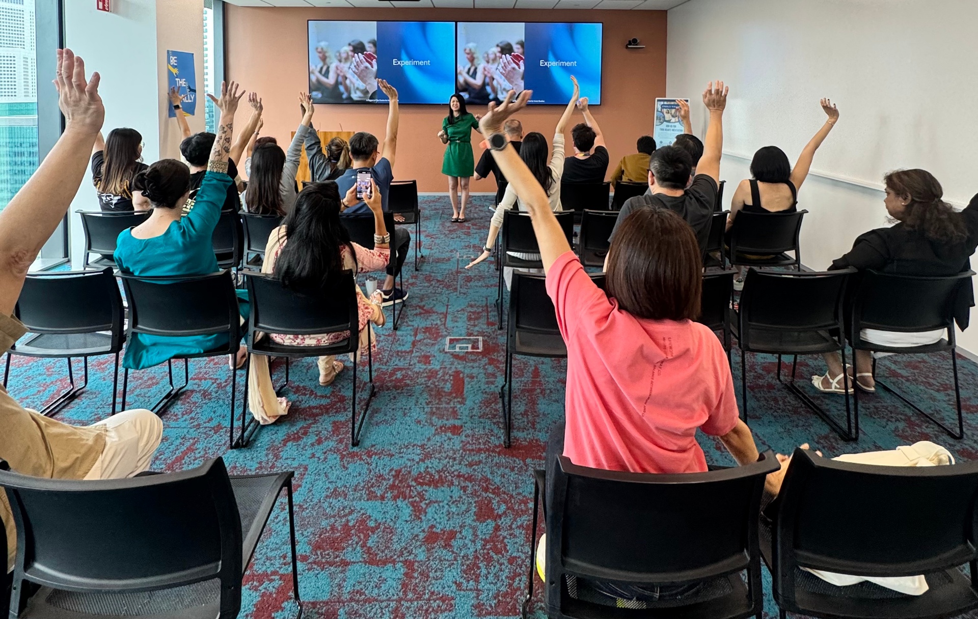 Audience raising their hands during a guided exercise